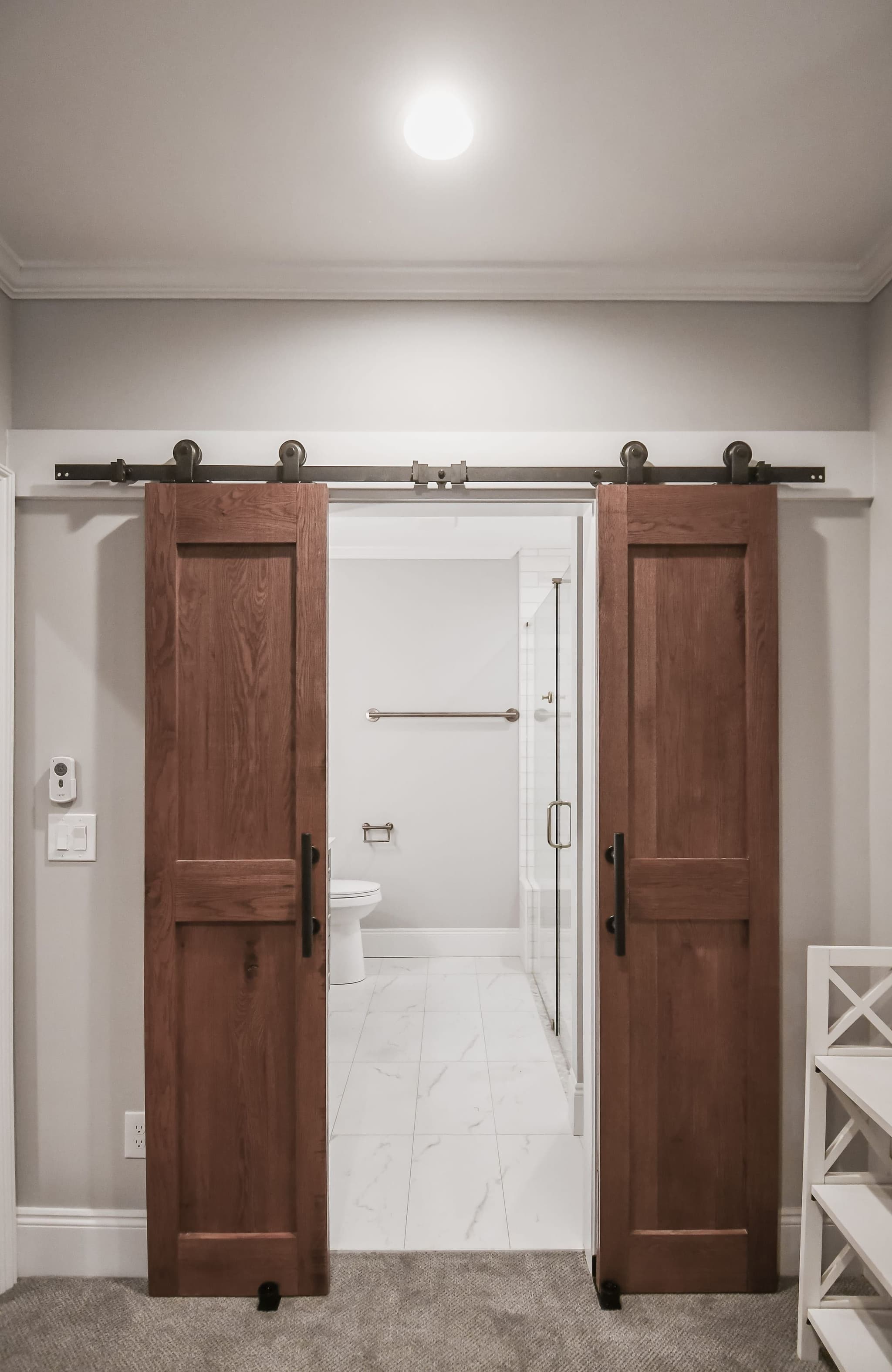 Finished basement suite with a bath behind custom sliding barn doors
