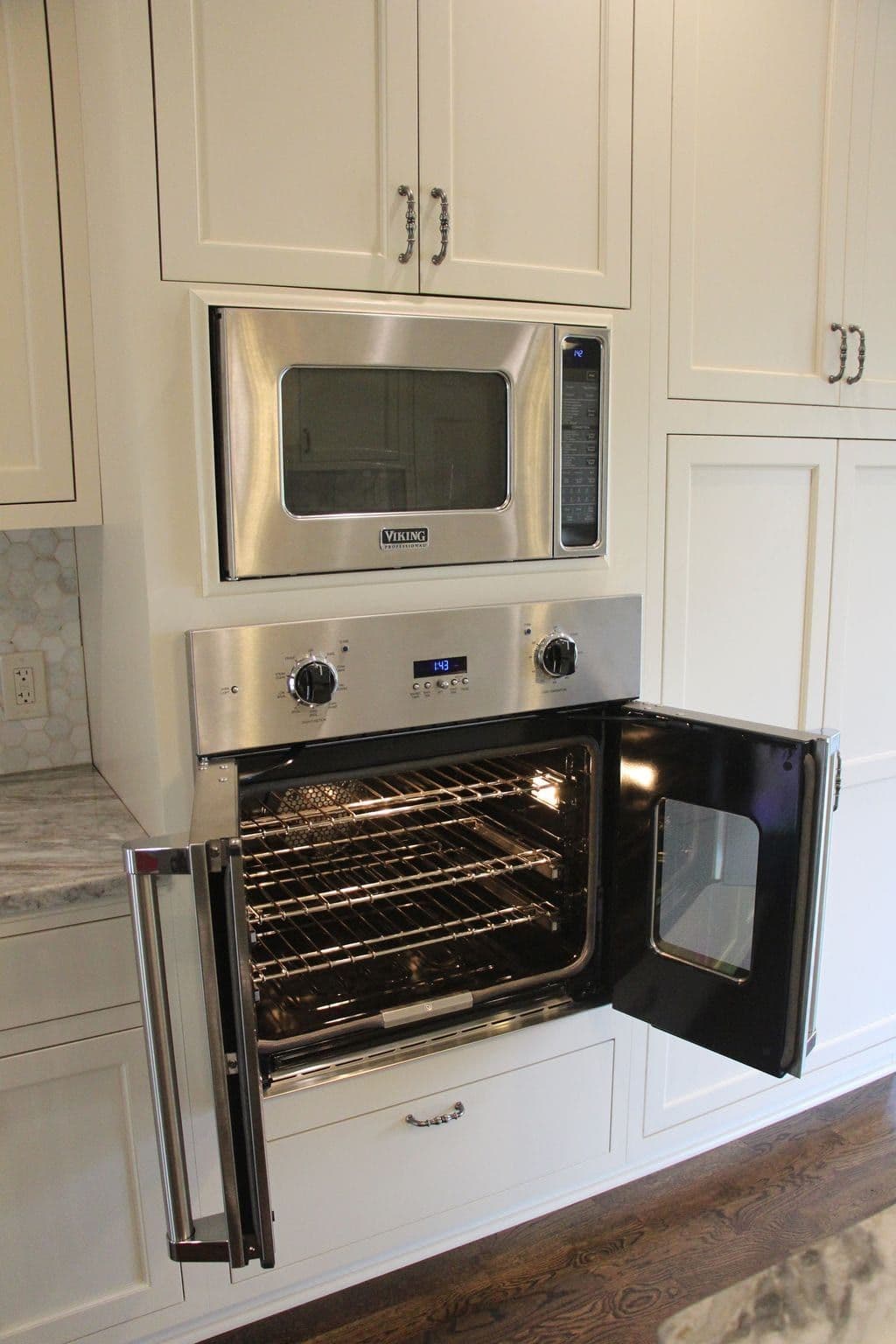 Custom kitchen with a Viking wall oven and inset cream cabinetry